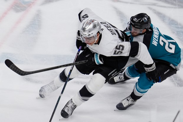 Kings right wing Quinton Byfield, left, and San Jose Sharks...