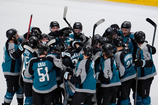 San Jose Sharks goaltender Yaroslav Askarov (30) celebrates with teammates...