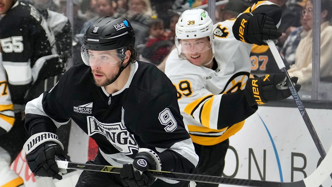 Los Angeles Kings right wing Adrian Kempe, left, skates as Boston Bruins center Morgan Geekie follows during the second period of an NHL hockey game Friday, Nov. 21, 2025, in Los Angeles. (AP Photo/Mark J. Terrill)