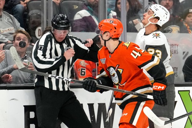Anaheim Ducks right wing Beckett Sennecke, center, and Vegas Golden...