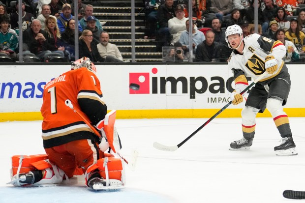 Vegas Golden Knights center Jack Eichel, right, puts a shot...