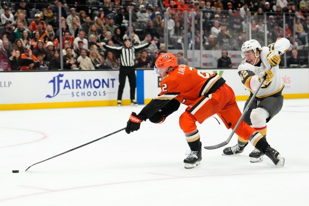 Vegas Golden Knights right wing Braeden Bowman, right, tries to...