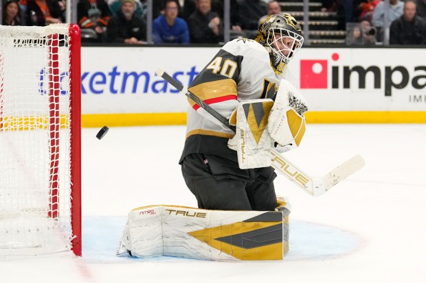 Vegas Golden Knights goaltender Akira Schmid deflects a shot during...
