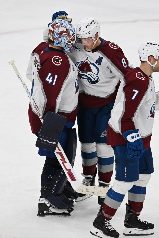 Colorado Avalanche goalie Scott Wedgewood (41) celebrates with teammate Cale Makar (8) after defeating the Chicago Blackhawks in an NHL hockey game, Sunday, Nov. 23, 2025, in Chicago. (AP Photo/Paul Beaty)