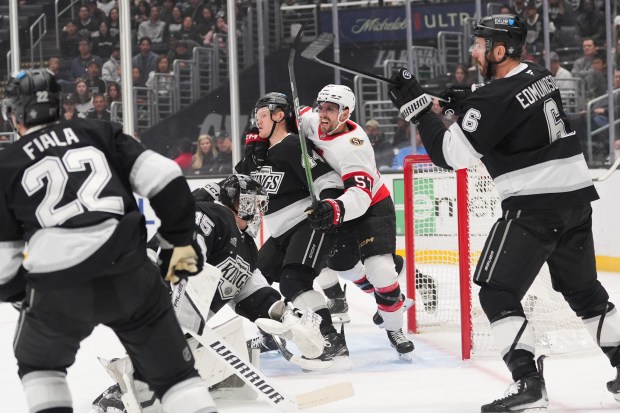 Ottawa Senators left wing David Perron (57) grabs Kings defenseman...