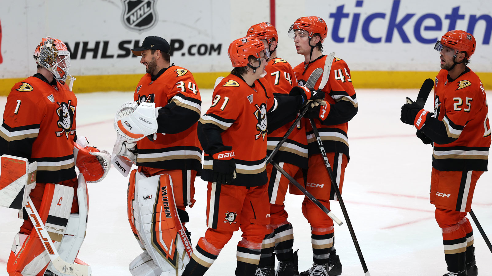 Anaheim Ducks right wing Beckett Sennecke (45) celebrates a win with center Leo Carlsson (91) after defeating the Winnipeg Jets 4-1 at Honda Center.
