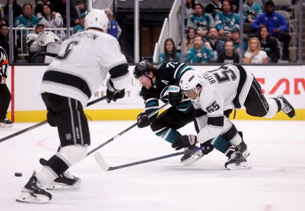 Los Angeles Kings’ Quinton Byfield #55 trips over San Jose...