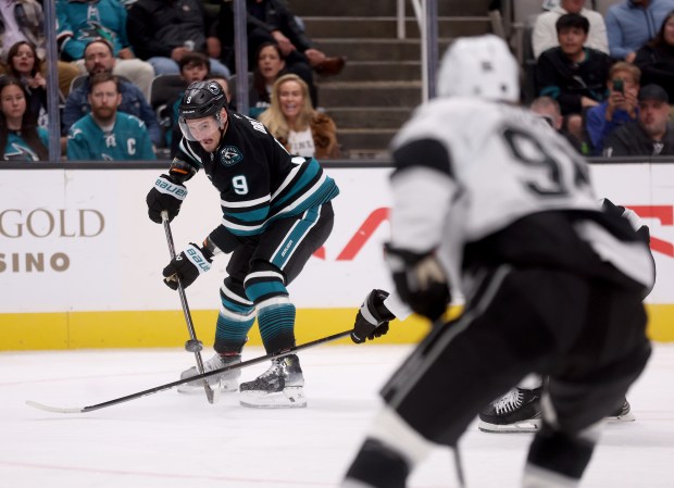 San Jose Sharks’ Dmitry Orlov #9 battles for the puck...