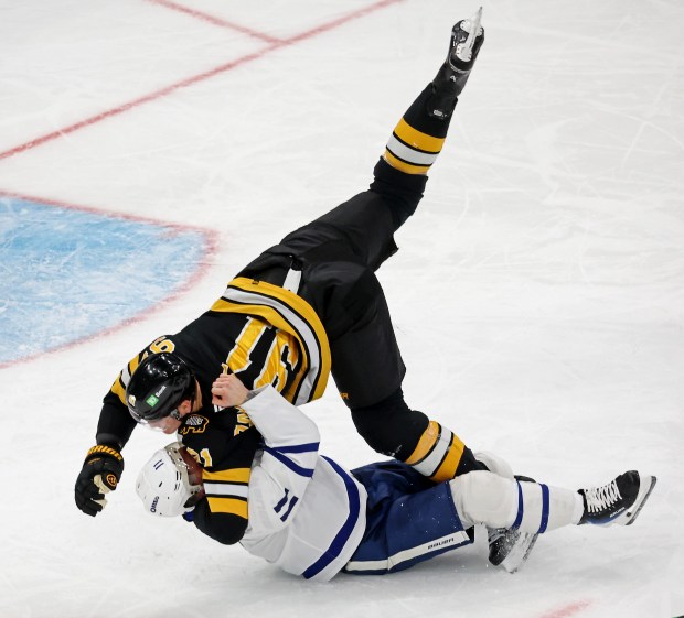 Toronto Maple Leafs center Max Domi (11) takes down Boston Bruins defenseman Nikita Zadorov in an attempted fight during the third period. (Staff Photo By Stuart Cahill/Boston Herald) 