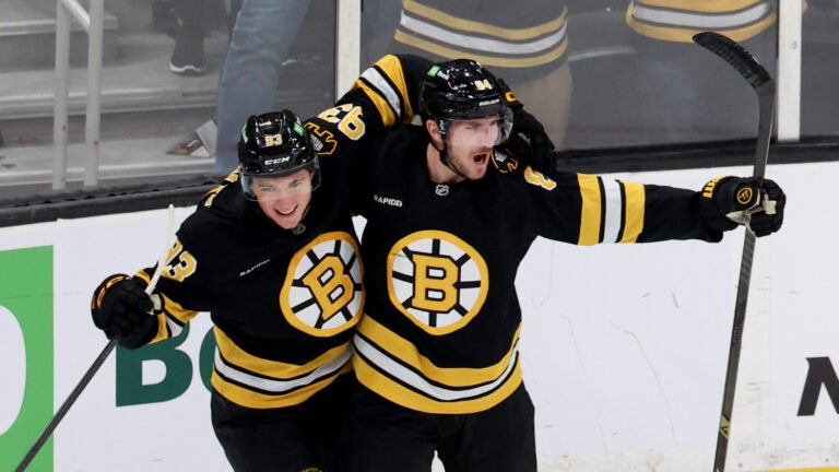 Boston Bruins center Fraser Minten, left, and Boston Bruins left wing Tanner Jeannot, right, celebrate after Jeannot's goal during the second period of an NHL hockey game against the Chicago Blackhawks, Thursday, Oct. 9, 2025, in Boston.