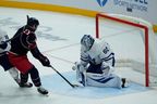 Toronto Maple Leafs goaltender Joseph Woll (60) makes a save against Columbus Blue Jackets center Sean Monahan (23) during third period of an NHL hockey game, Wednesday, Nov. 26, 2025, in Columbus, Ohio. (AP Photo/Carolyn Kaster)