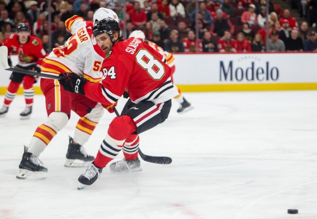 Blackhawks left wing Landon Slaggert (84) chases the puck during the first period against the Calgary Flames, Nov. 18, 2025, at the United Center. (Dominic Di Palermo/Chicago Tribune)