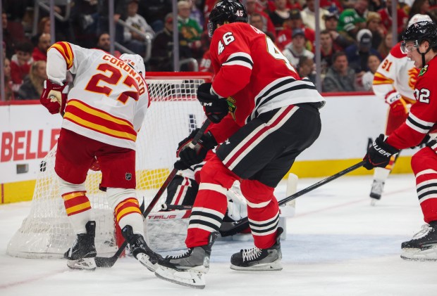 Flames right wing Matt Coronato (27) scores the first goal for the Flames on Blackhawks goaltender Arvid Soderblom (40) during the second period, Nov. 18, 2025, at the United Center. (Dominic Di Palermo/Chicago Tribune)