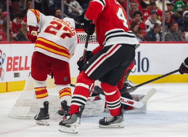 Flames right wing Matt Coronato (27) scores the first goal for the Flames on Blackhawks goaltender Arvid Soderblom (40) during the second period, Nov. 18, 2025, at the United Center. (Dominic Di Palermo/Chicago Tribune)