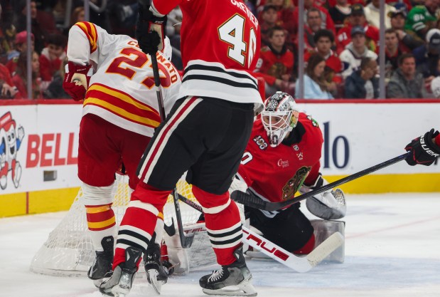 Flames right wing Matt Coronato (27) scores the first goal for the Flames on Blackhawks goaltender Arvid Soderblom (40) during the second period, Nov. 18, 2025, at the United Center. (Dominic Di Palermo/Chicago Tribune)