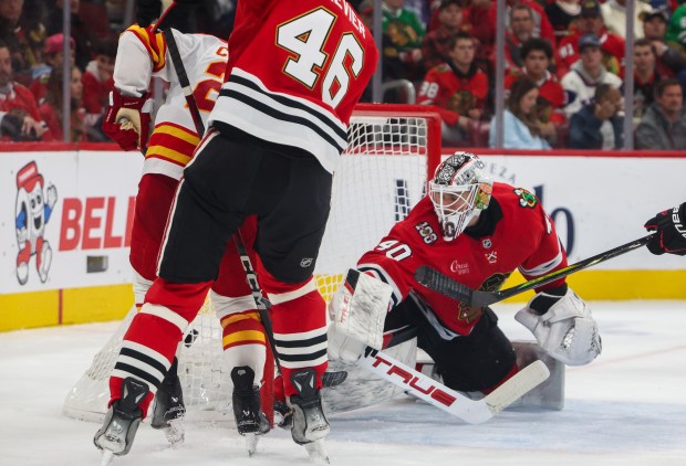 Flames right wing Matt Coronato (27) scores the first goal for the Flames on Blackhawks goaltender Arvid Soderblom (40) during the second period, Nov. 18, 2025, at the United Center. (Dominic Di Palermo/Chicago Tribune)
