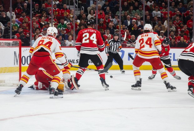 Blackhawks center Ryan Donato (8), right, shoots and scores during the first period against the Calgary Flames, Nov. 18, 2025, at the United Center. (Dominic Di Palermo/Chicago Tribune)