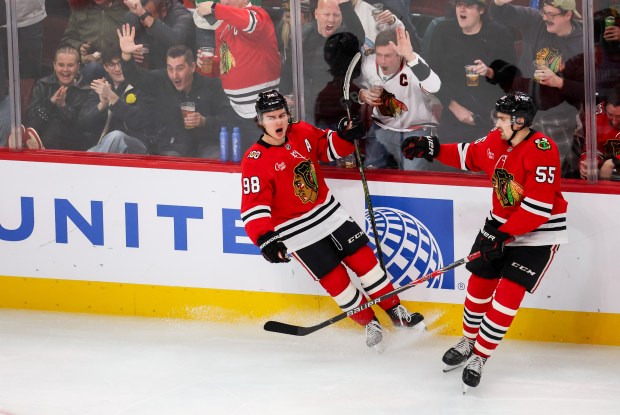 Blackhawks center Connor Bedard (98) celebrates his second goal with Blackhawks defenseman Artyom Levshunov (55) during the third period against the Calgary Flames bringing the Blackhawks up 3-2, Nov. 18, 2025, at the United Center. (Dominic Di Palermo/Chicago Tribune)