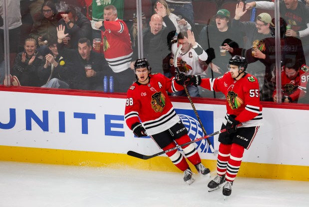 Blackhawks center Connor Bedard (98) celebrates his second goal with Blackhawks defenseman Artyom Levshunov (55) during the third period against the Calgary Flames bringing the Blackhawks up 3-2, Nov. 18, 2025, at the United Center. (Dominic Di Palermo/Chicago Tribune)