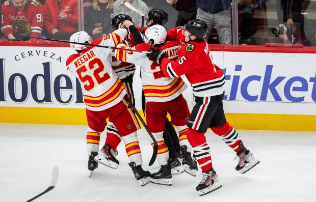 A scrum ensues between Blackhawks and Calgary Flames players during the third period, Nov. 18, 2025, at the United Center. (Dominic Di Palermo/Chicago Tribune)
