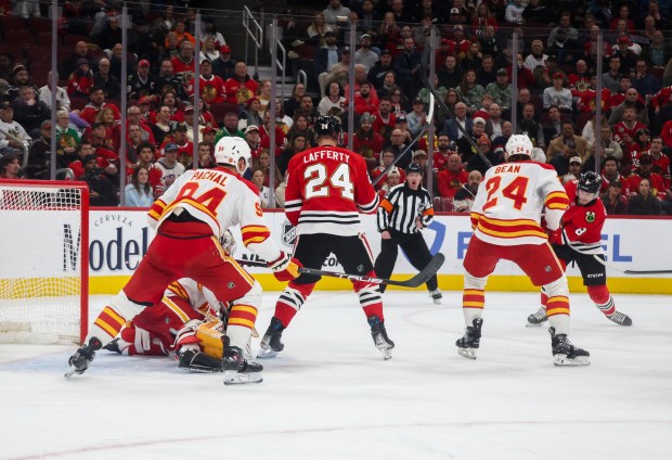 Blackhawks center Ryan Donato (8), right, shoots and scores during the first period against the Calgary Flames, Nov. 18, 2025, at the United Center. (Dominic Di Palermo/Chicago Tribune)