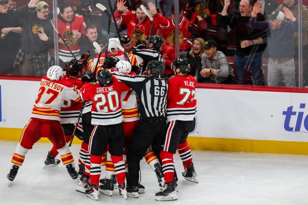 A scrum ensues between Blackhawks and Calgary Flames players during the third period, Nov. 18, 2025, at the United Center. (Dominic Di Palermo/Chicago Tribune)