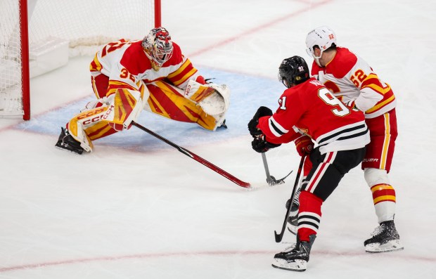 Blackhawks center Frank Nazar (91) shoots on goal while being contested by Flames defenseman MacKenzie Weegar (52) during the third period, Nov. 18, 2025, at the United Center. (Dominic Di Palermo/Chicago Tribune)