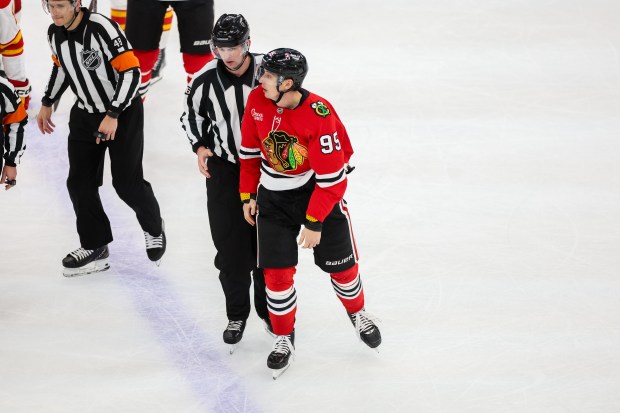 Blackhawks right wing Ilya Mikheyev (95) is taken to the penalty box for a roughing penalty during the third period against the Calgary Flames, Nov. 18, 2025, at the United Center. (Dominic Di Palermo/Chicago Tribune)