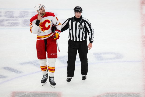 Flames right wing Adam Klapka (43) is taken to the penalty box for a roughing penalty during the third period against the Blackhawks, Nov. 18, 2025, at the United Center. (Dominic Di Palermo/Chicago Tribune)