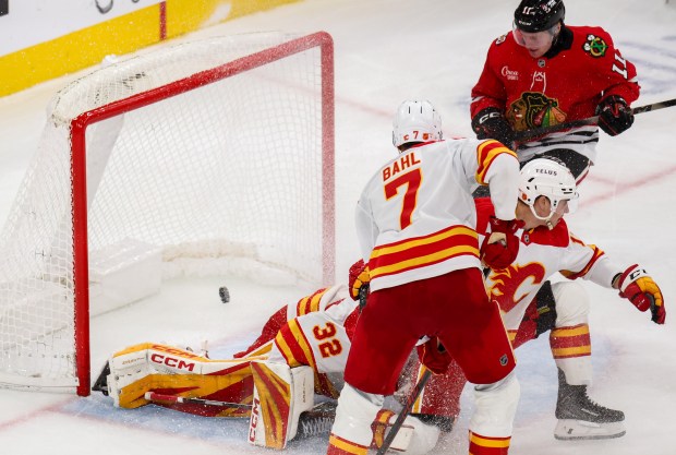 Blackhawks center Oliver Moore (11) scores bringing the Blackhawks up 4-2 during the third period against the Calgary Flames, Nov. 18, 2025, at the United Center. (Dominic Di Palermo/Chicago Tribune)