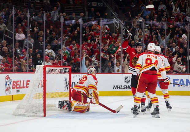 Blackhawks center Sam Lafferty (24) raises his stick in celebration of Blackhawks center Ryan Donato's goal during the first period against the Calgary Flames, Nov. 18, 2025, at the United Center. (Dominic Di Palermo/Chicago Tribune)