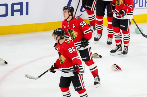 Blackhawks center Connor Bedard (98) skates among hats thrown on the ice by fans after his hat trick that brought the Blackhawks up 5-2 during the third period against the Calgary Flames, Nov. 18, 2025, at the United Center. (Dominic Di Palermo/Chicago Tribune)