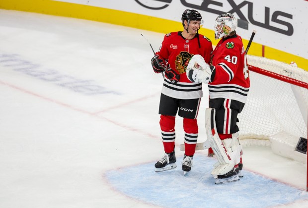 Blackhawks left wing Andre Burakovsky (28) and Blackhawks goaltender Arvid Soderblom (40) talk while a scrum ensued between players from the Blackhawks and Calgary Flames, Nov. 18, 2025, at the United Center. (Dominic Di Palermo/Chicago Tribune)