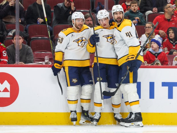 Nashville Predators left wing Michael Bunting (58) and defenseman Nicolas Hague (41) celebrate Nashville Predators right wing Matthew Wood's (71) during the second period against the Blackhawks, Nov. 28, 2025, at the United Center. (Dominic Di Palermo/Chicago Tribune)