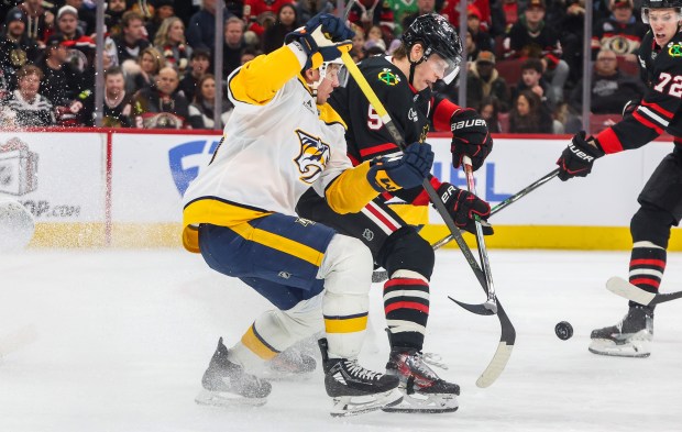 Blackhawks defenseman Connor Murphy (5) and Nashville Predators left wing Erik Haula (56) battle for the puck during the second period, Nov. 28, 2025, at the United Center. (Dominic Di Palermo/Chicago Tribune)