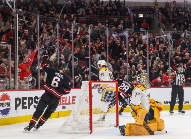 Blackhawks defenseman Sam Rinzel (6) celebrates his assist on Blackhawks center Ryan Donato's goal during the first period against the Nashville Predators, Nov. 28, 2025, at the United Center. (Dominic Di Palermo/Chicago Tribune)