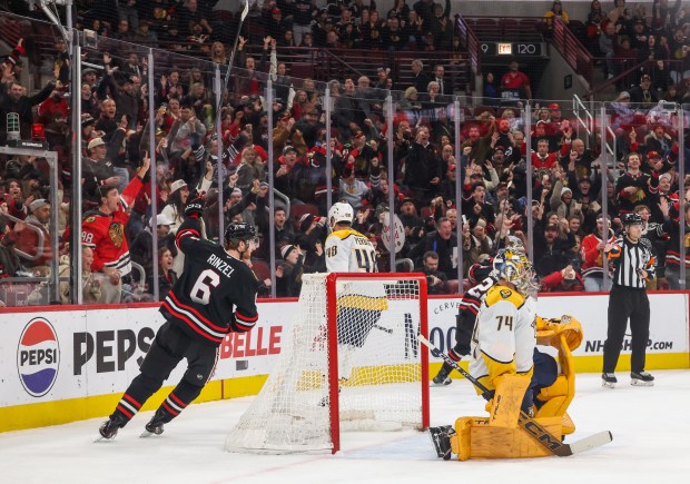 Blackhawks defenseman Sam Rinzel (6) celebrates his assist on Blackhawks center Ryan Donato's goal during the first period against the Nashville Predators, Nov. 28, 2025, at the United Center. (Dominic Di Palermo/Chicago Tribune)