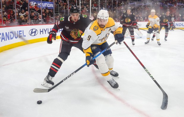 Blackhawks defenseman Louis Crevier (46) and Nashville Predators left wing Filip Forsberg (9) race for the puck during the second period, Nov. 28, 2025, at the United Center. (Dominic Di Palermo/Chicago Tribune)