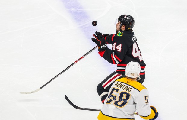 Blackhawks defenseman Wyatt Kaiser (44) swats the puck out of the air during the second period against the Nashville Predators, Nov. 28, 2025, at the United Center. (Dominic Di Palermo/Chicago Tribune)