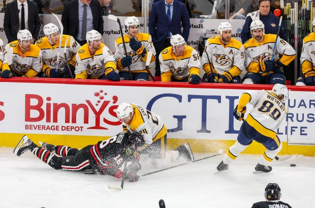 Nashville Predators right wing Ozzy Wiesblatt (89) handles the puck while Blackhawks center Jason Dickinson (16) and Nashville Predators defenseman Spencer Stastney (24) collide during the third period, Nov. 28, 2025, at the United Center. (Dominic Di Palermo/Chicago Tribune)