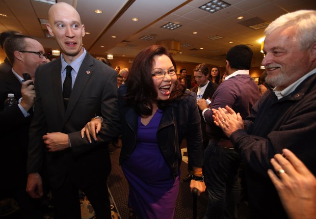 Escorted by friend Scott Waddl, northwest suburban 8th Congressional District candidate Democrat Tammy Duckworth makes her entrance into the ballroom to give her victory speech at the Holiday Inn in Elk Grove Village, on Nov. 6, 2012. (Stacey Wescott/Chicago Tribune)