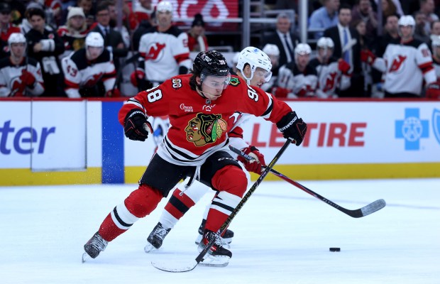 Blackhawks center Connor Bedard battles for the puck in the first period against the Devils on Wednesday, Nov. 12, 2025, at the United Center. (Chris Sweda/Chicago Tribune)
