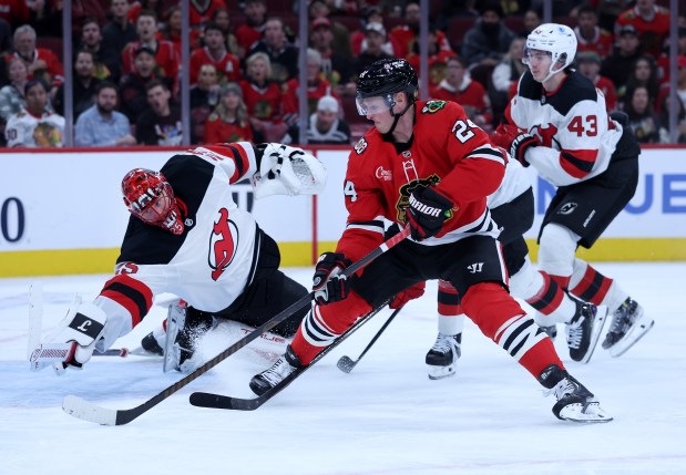 Blackhawks center Sam Lafferty scores a goal on Devils goaltender Jacob Markstrom in the third period Wednesday, Nov. 12, 2025, at the United Center. (Chris Sweda/Chicago Tribune)