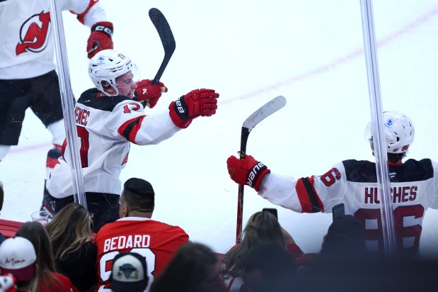 Devils defenseman Simon Nemec (17) celebrates with his teammates after scoring the game-winning goal in overtime against the Blackhawks on Wednesday, Nov. 12, 2025, at the United Center. (Chris Sweda/Chicago Tribune)