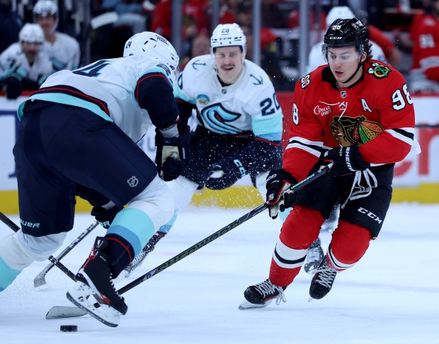 Chicago Blackhawks center Connor Bedard (98) looks to take control of the puck in the first period of a game against the Seattle Kraken at the United Center in Chicago on Nov. 20, 2025. (Chris Sweda/Chicago Tribune)