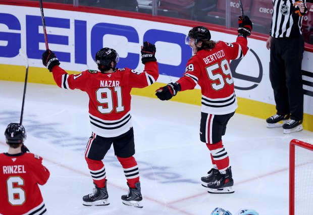 Chicago Blackhawks left wing Tyler Bertuzzi (59) celebrates with Chicago Blackhawks center Frank Nazar (91) after Bertuzzi scored a goal on Seattle Kraken goaltender Joey Daccord in the second period of a game at the United Center in Chicago on Nov. 20, 2025. (Chris Sweda/Chicago Tribune)
