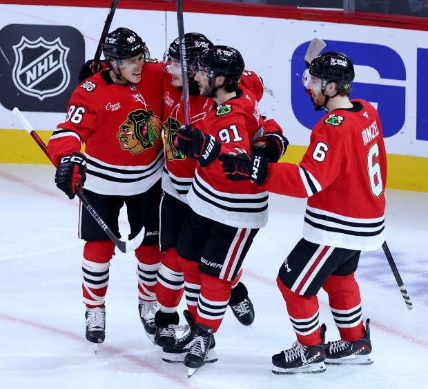 Chicago Blackhawks left wing Tyler Bertuzzi (second from left) celebrates with his teammates after scoring a goal on Seattle Kraken goaltender Joey Daccord in the second period of a game at the United Center in Chicago on Nov. 20, 2025. (Chris Sweda/Chicago Tribune)