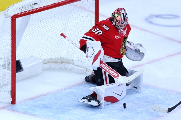 Chicago Blackhawks goaltender Spencer Knight (30) blocks a shot in the second period of a game against the Seattle Kraken at the United Center in Chicago on Nov. 20, 2025. (Chris Sweda/Chicago Tribune)