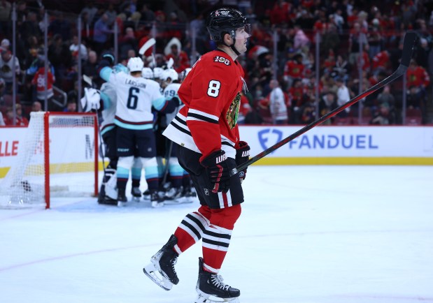 Blackhawks center Ryan Donato (8) leaves the ice as the Kraken celebrate their 3-2 victory on Nov. 20, 2025, at the United Center. (Chris Sweda/Chicago Tribune)