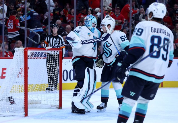Seattle Kraken goaltender Joey Daccord (35) and defenseman Ryan Lindgren (55) celebrate after their victory over the Chicago Blackhawks at the United Center in Chicago on Nov. 20, 2025. (Chris Sweda/Chicago Tribune)